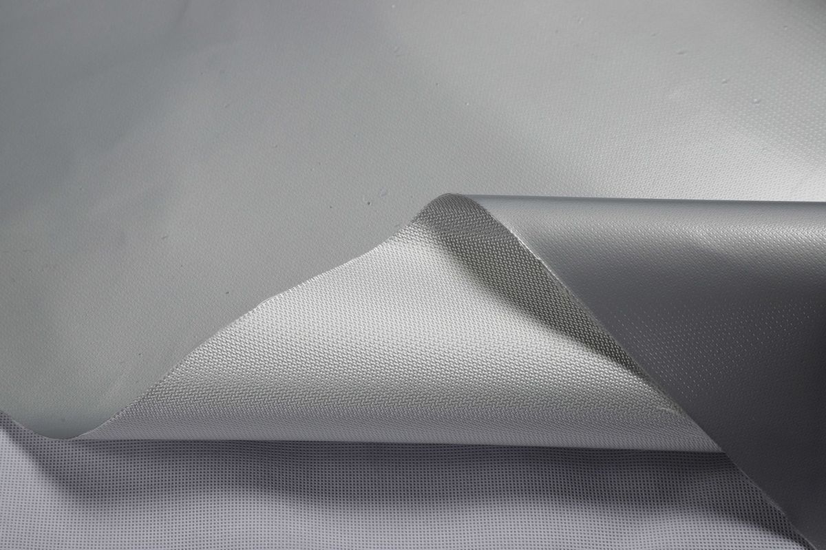 Grey silicone-coated fiberglass with one corner turned to show the white woven reverse